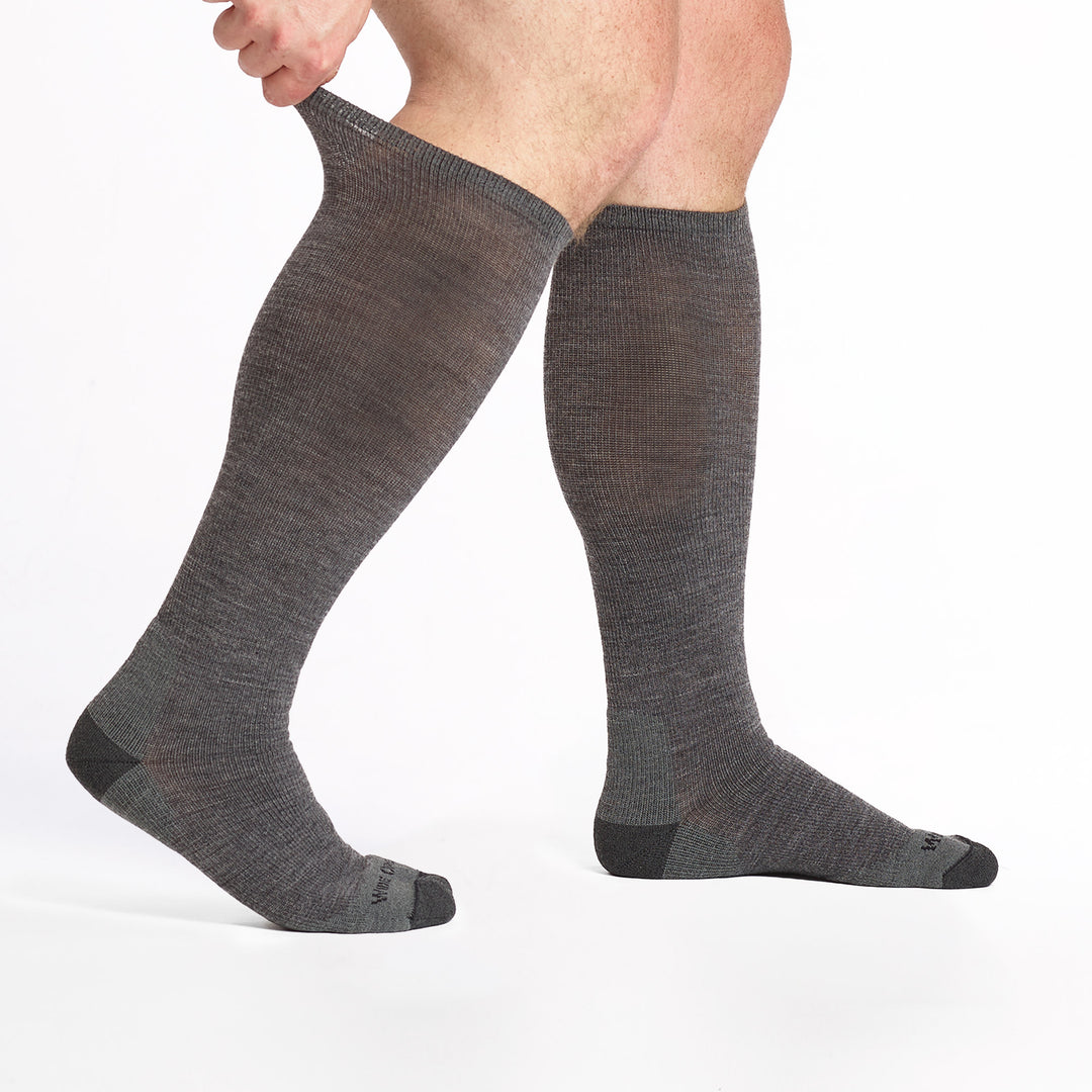 9017 gray knee high with charcoal heel/toe/logo shown from the side with top cuff stretched