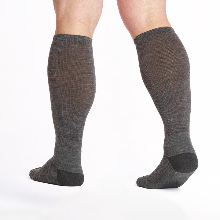 9017 Gray knee high socks with charcoal heel/toe/logo shown from behind with lifted heel
