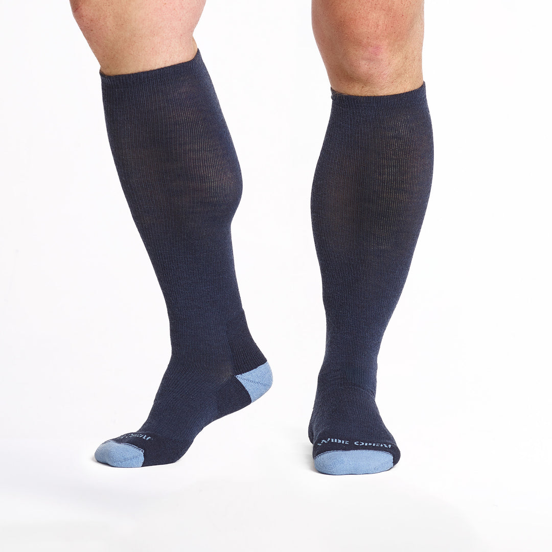 9017 navy knee high socks with light blue heel/toe/logoshown from the front and side with heeel lifted