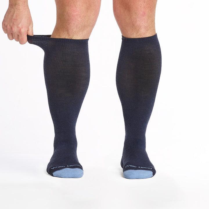 9017-navy knee high socks with light blue heel/toe/logo shown from the front the cuff being stretched