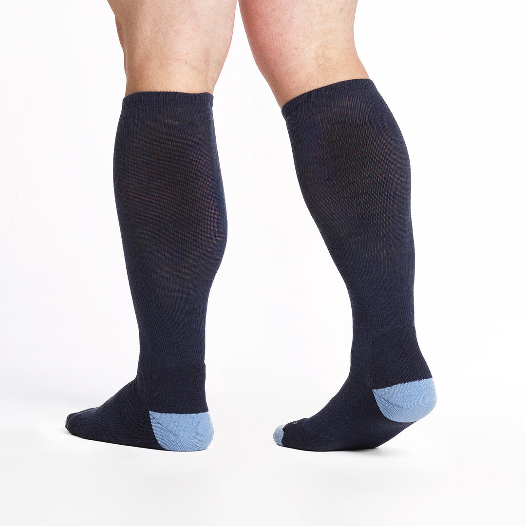 9017 Navy keen high sock with light blue heel/toe/logo, shown from behind with lifted heal