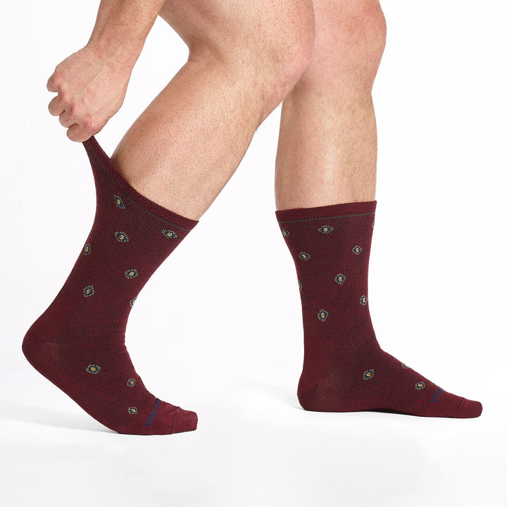 9018 burgundy crew sock blue logo, taupe geometric dots shown from the side with back cuff being stretched