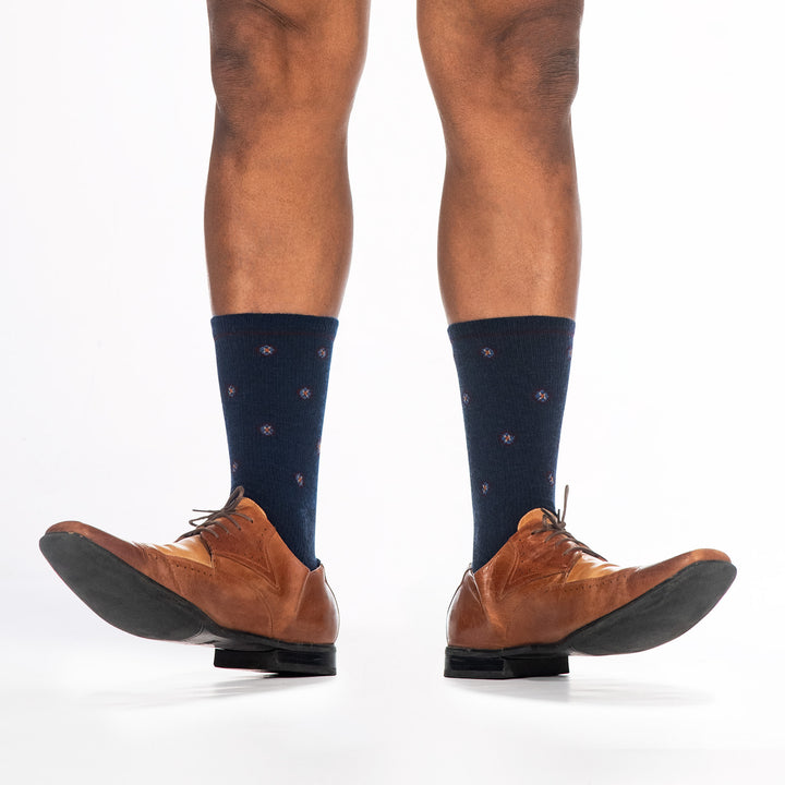 9018 navy crew sock in a pair of dress shoes with toes raised, shown from the front 
