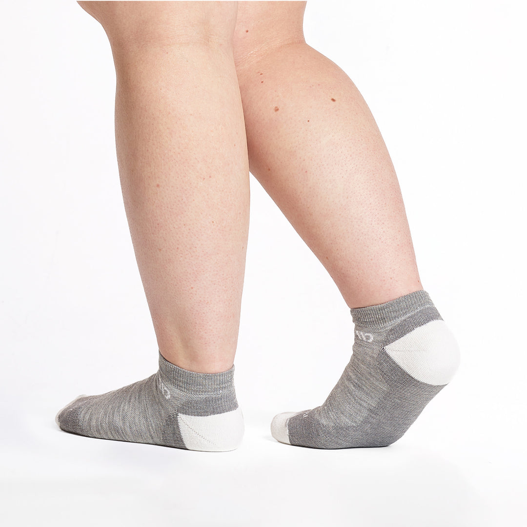 9500 lt gray ankle sock with white heel/toe/logo shown from the back and side with back foot lifted