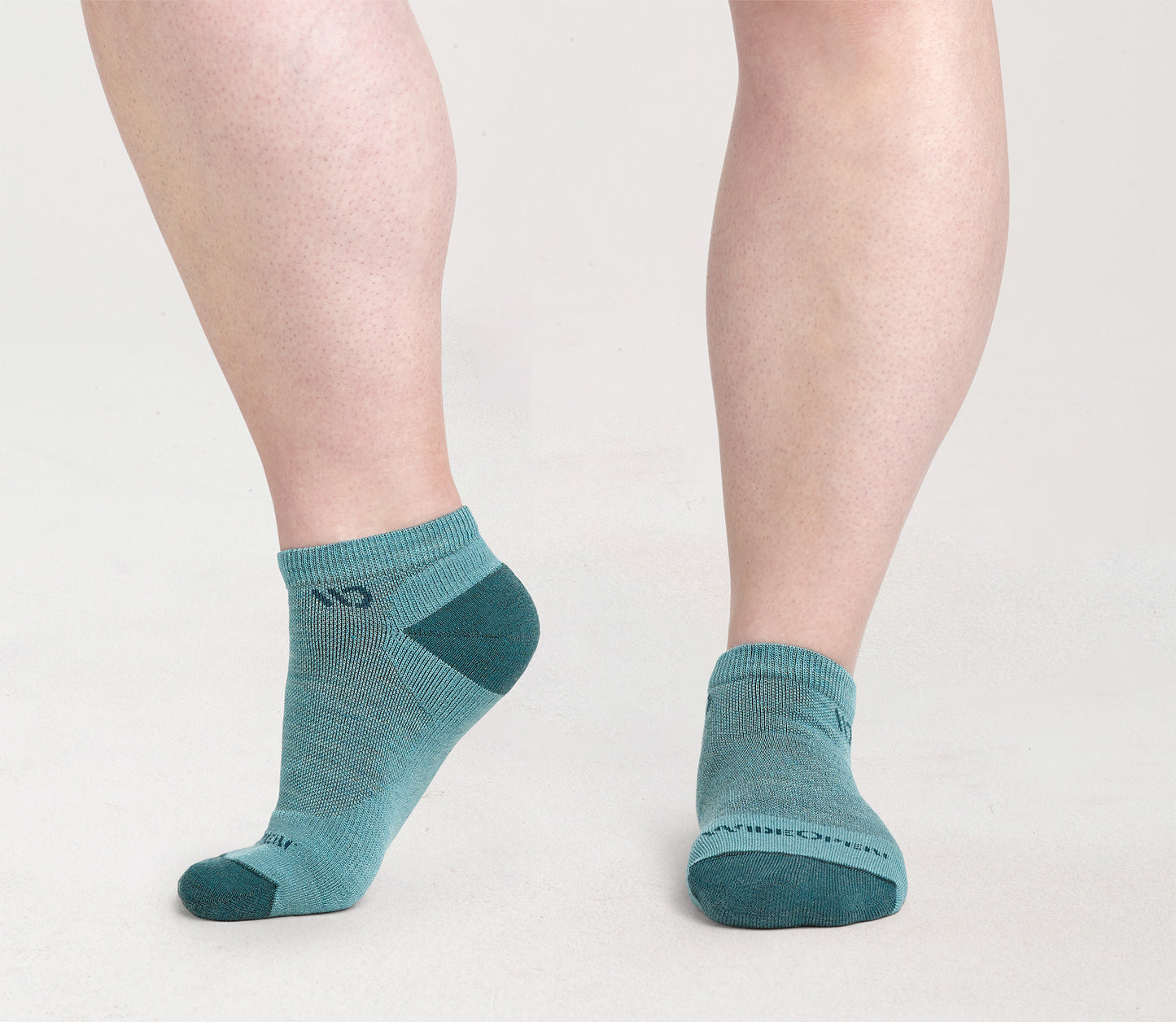 On model: No shows with dark teal heel/toe and logo, with light teal body --Light Teal