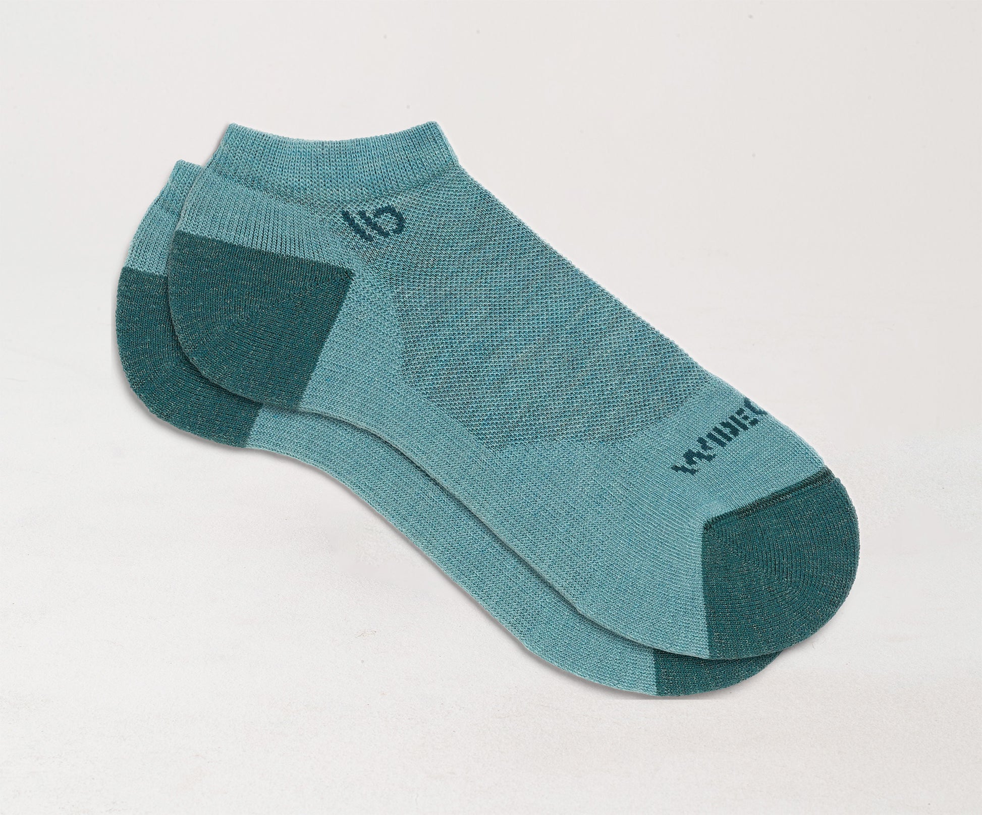 Flat socks featuring teal heel/toe and logo, with light teal body --Light Teal