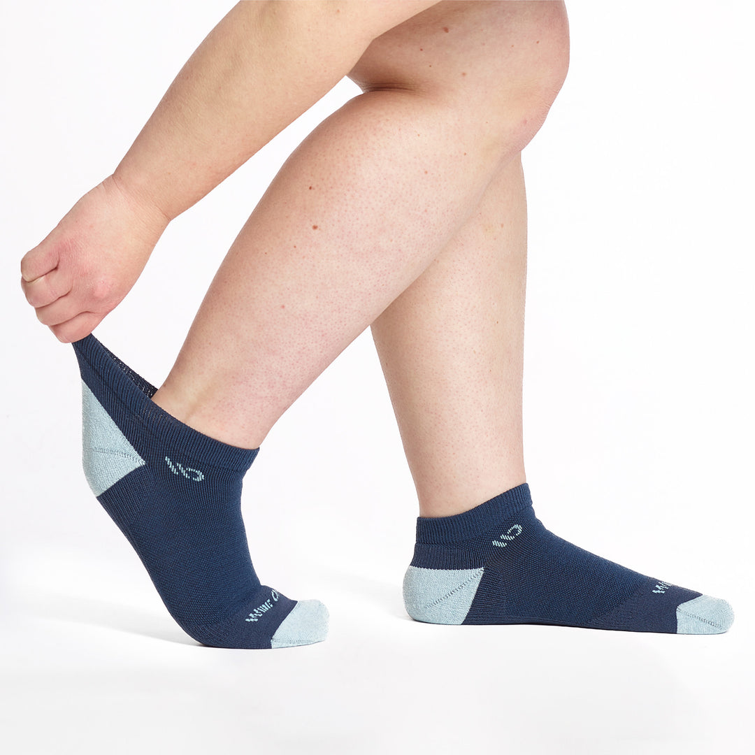 9500-Navy ankle sock with light blue heel/toe/logo, shown from the side with back foot cuff stretched out.