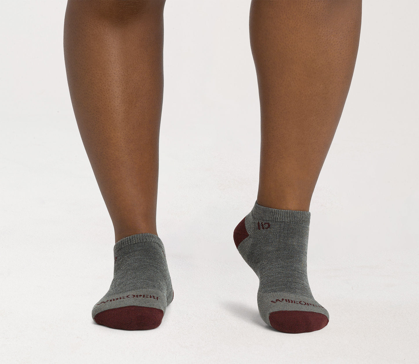 On model: No Shows with maroon heel/toe and logo, with taupe body --Taupe