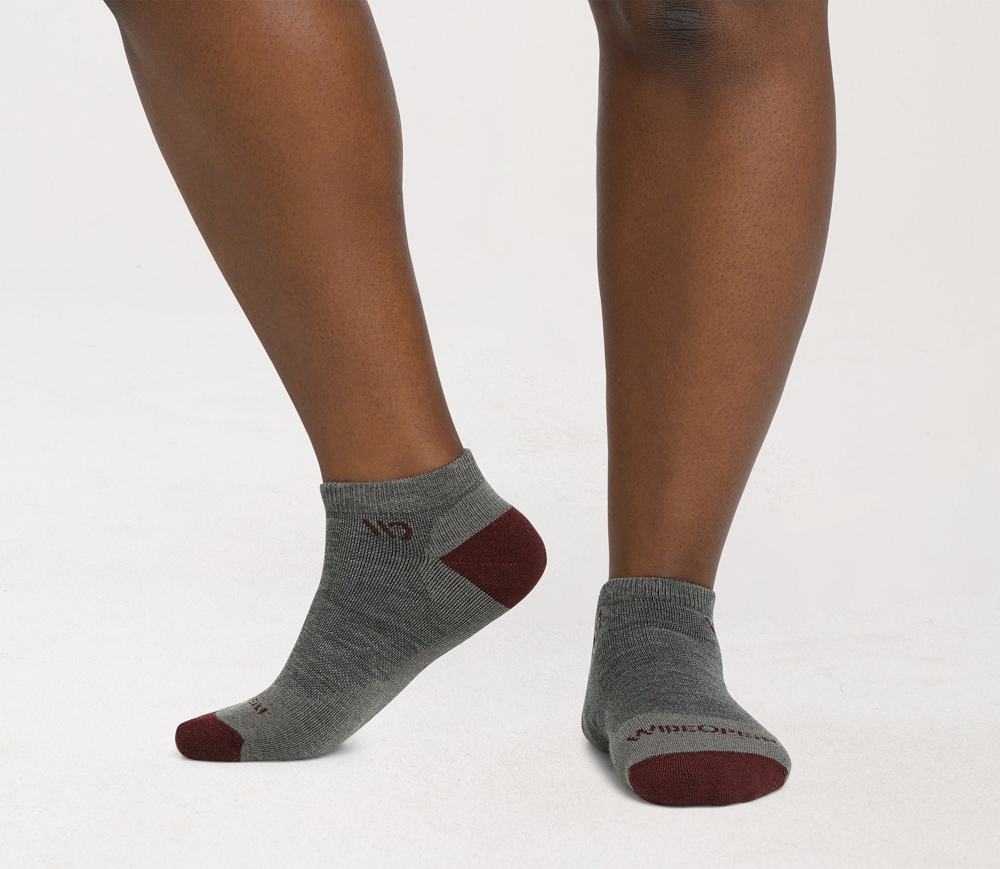 On model: No Shows with maroon heel/toe and logo, with taupe body --Taupe