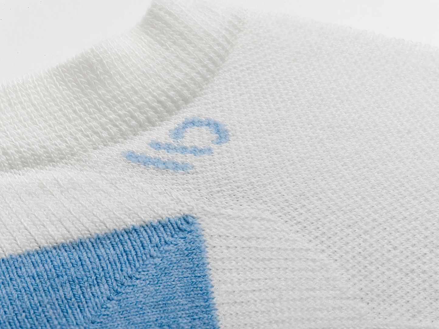 Detail featuring a logo in light blue and heal, with solid White body --White