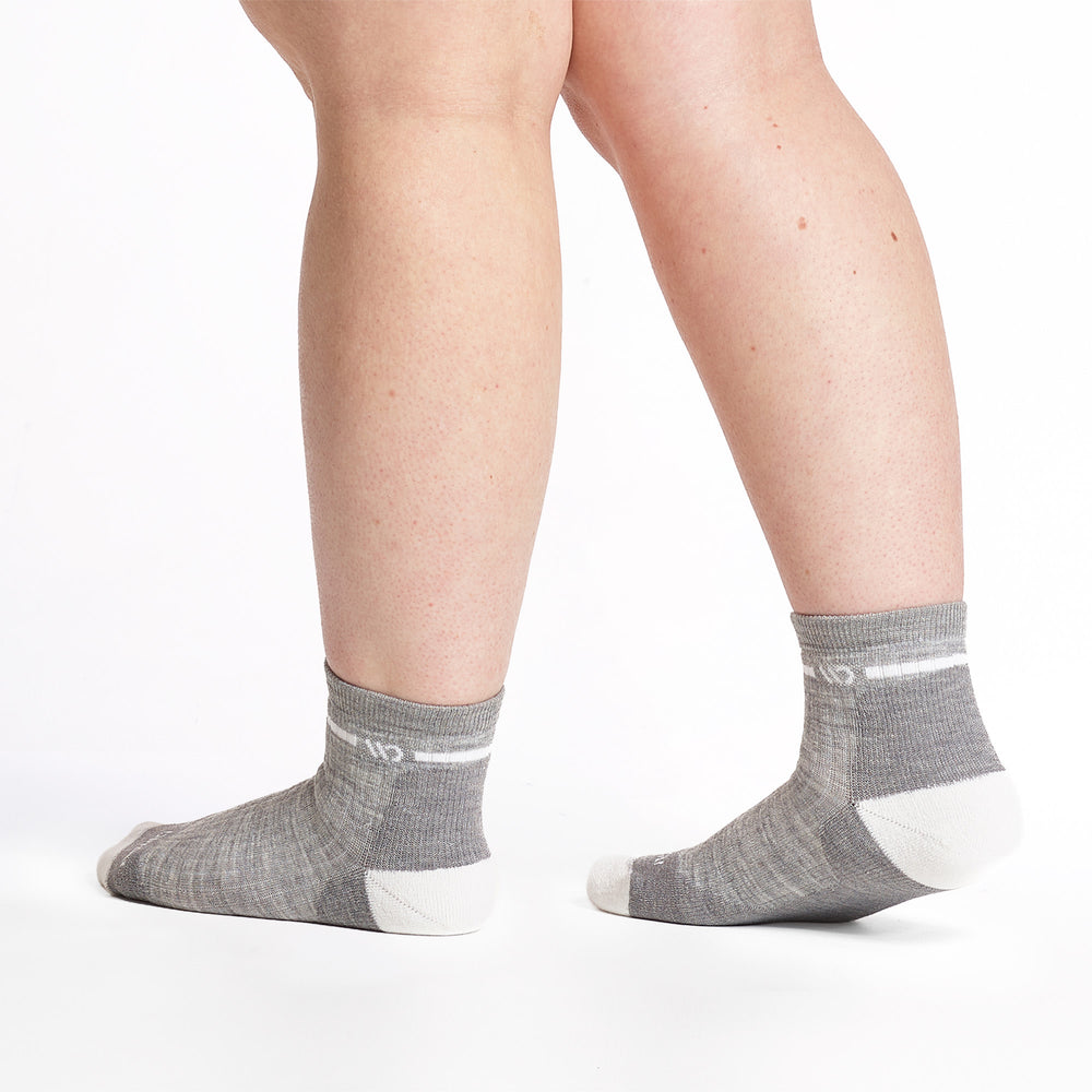 9501 lt gray quarter sock with white heel/toe/logo shown from the back and side feet pointing to the left