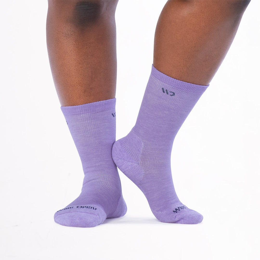 Model image lifting right foot so heel touches ankle wearing the 9504 in lavender