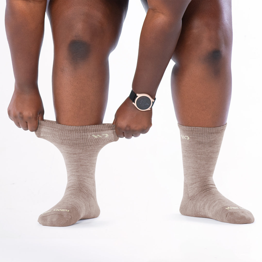 Model image stretching the cuff on the left side wearing the 9504 rye colorway