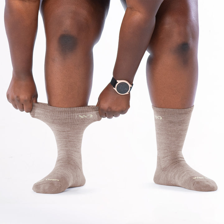 Model image stretching the cuff on the left side wearing the 9504 rye colorway