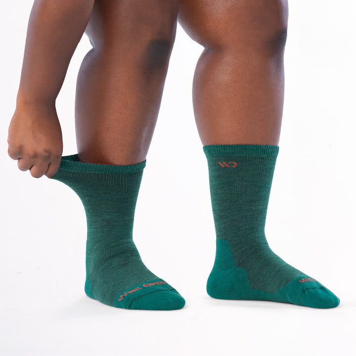 Model stretching the cuff on the left wearing the 9504 in teal colorway