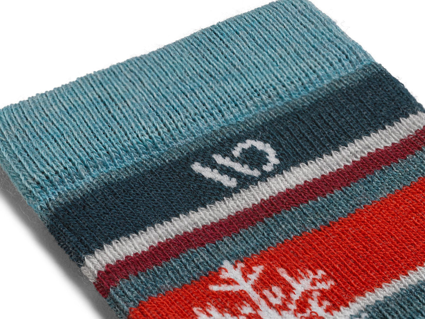 Detail featuring teal/red stripe with white snowflake and logo 