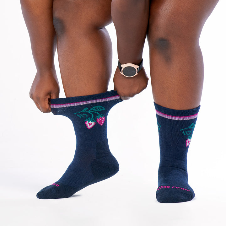 model stretching the cuff of the strawberry patch cushioned crew in eclipse