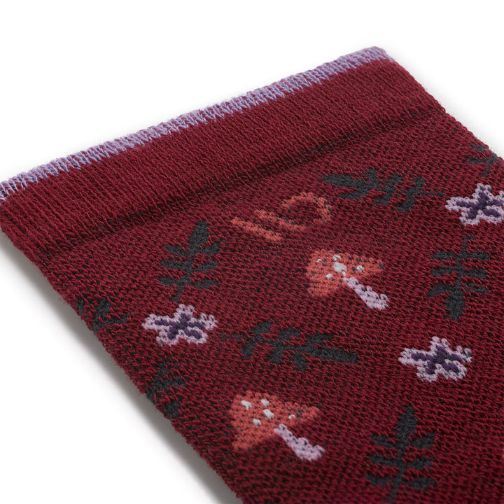 close up detail image of the 9512 wildwood cushioned crew in burgundy featuring mushrooms and ferns
