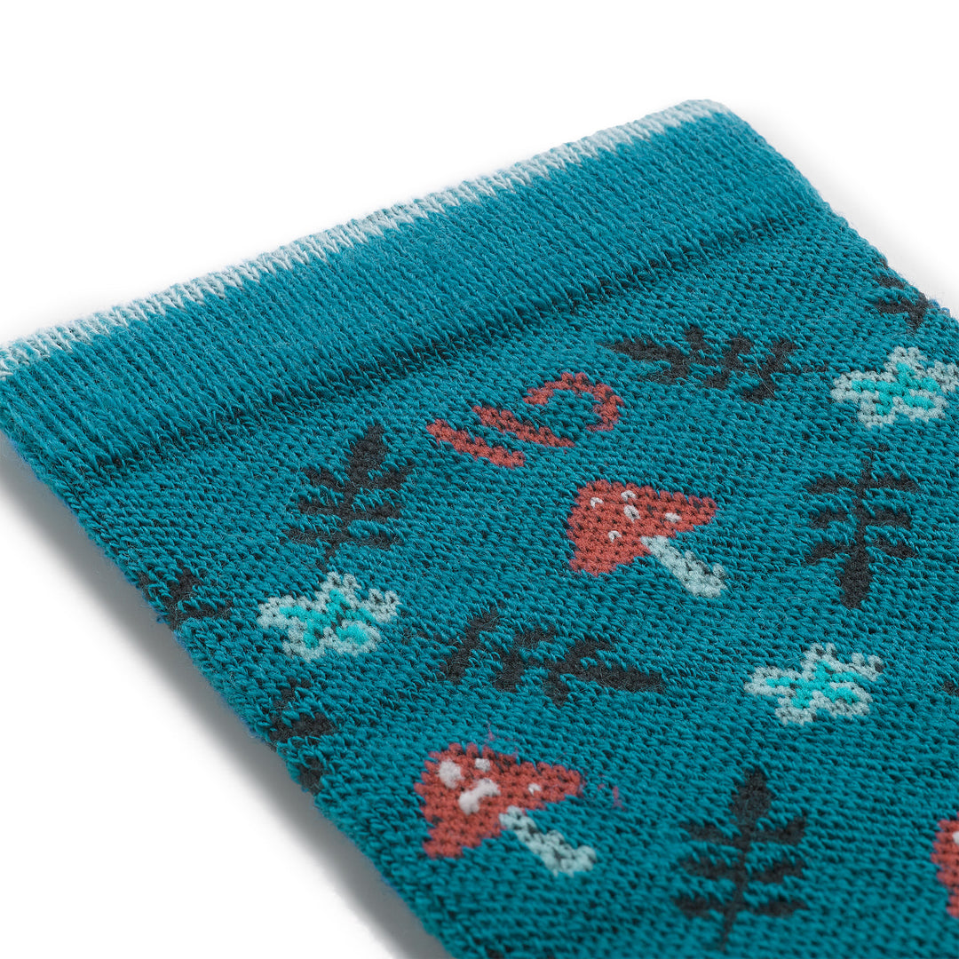close up detail image of the 9512 wildwood cushioned crew in bright teal featuring mushrooms and ferns
