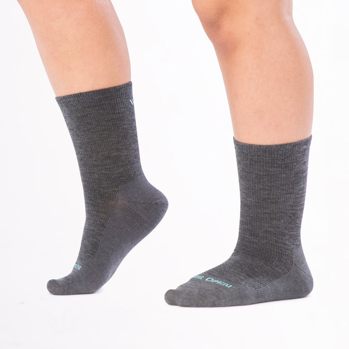 models feet positioned to the left with front foot lifted wearing 9513 solid basic lightweight crew in gray