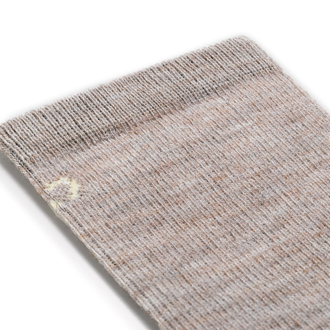 close up detail image of the 9513 solid basic lightweight crew in rye featuring a cream color logo on an oatmeal body
