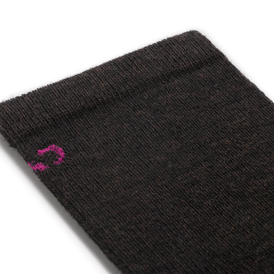 close up detail image of the 9513 solid basic lightweight crew in walnut featuring a pink logo on brown body