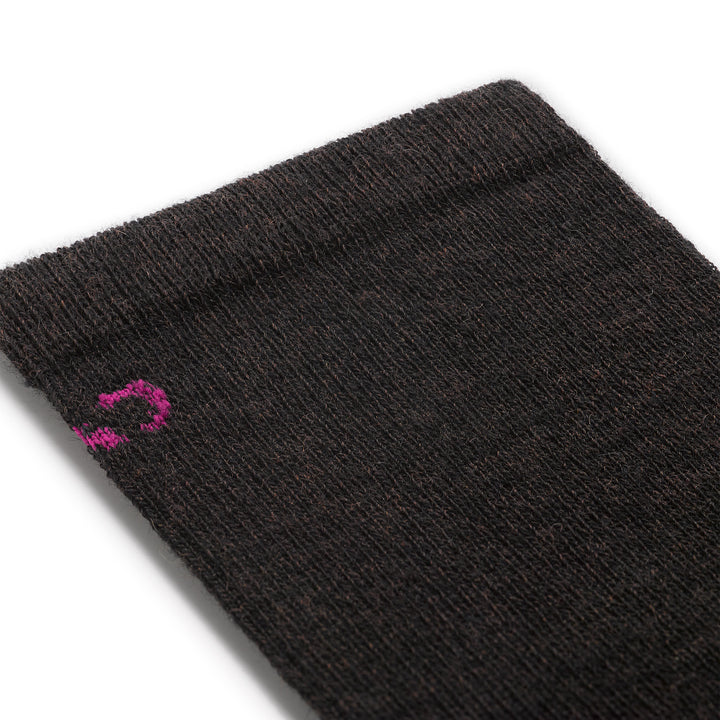 close up detail image of the 9513 solid basic lightweight crew in walnut featuring a pink logo on brown body