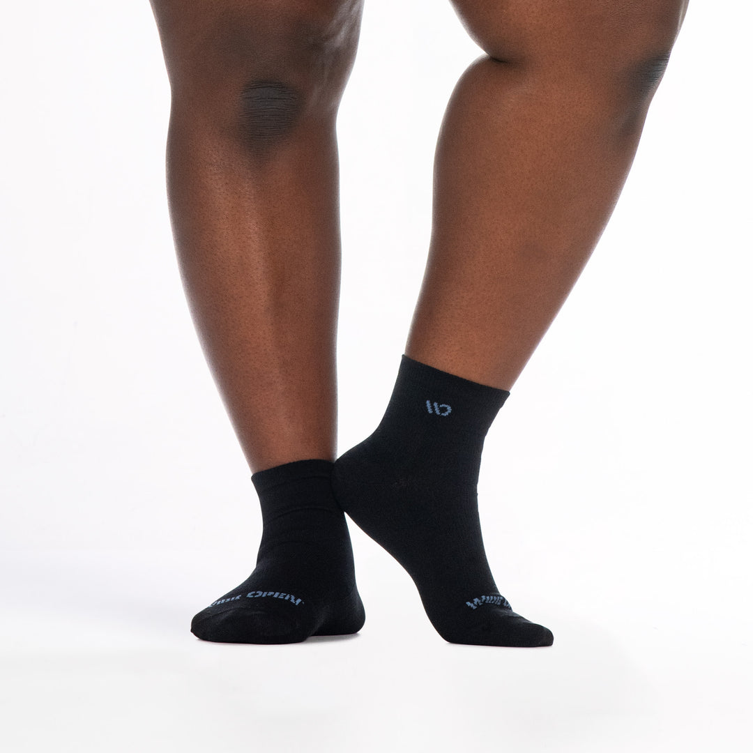 9515 black quarter sock blue logo, shown from front and side right heel raised touching left ankle