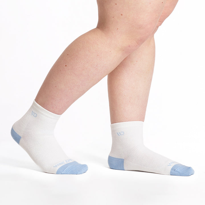 9515 white quarter sock with light blue heel/toe/logo shown from the side pointing to the right with back heel lifted