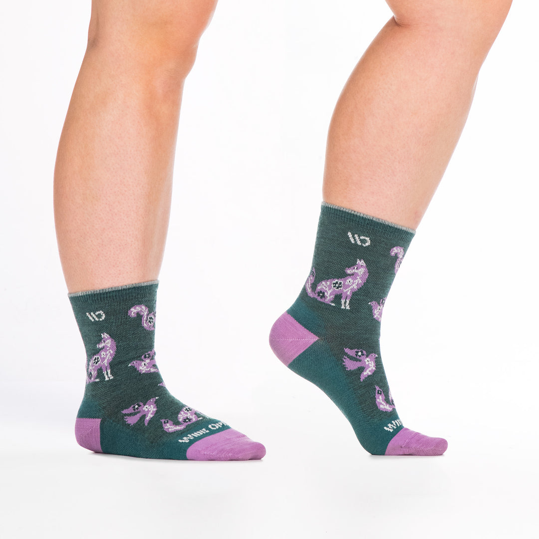 9516 teal micro crew sock with lavender heel/toe, white logo, shown with feet to the right with foot lifted 