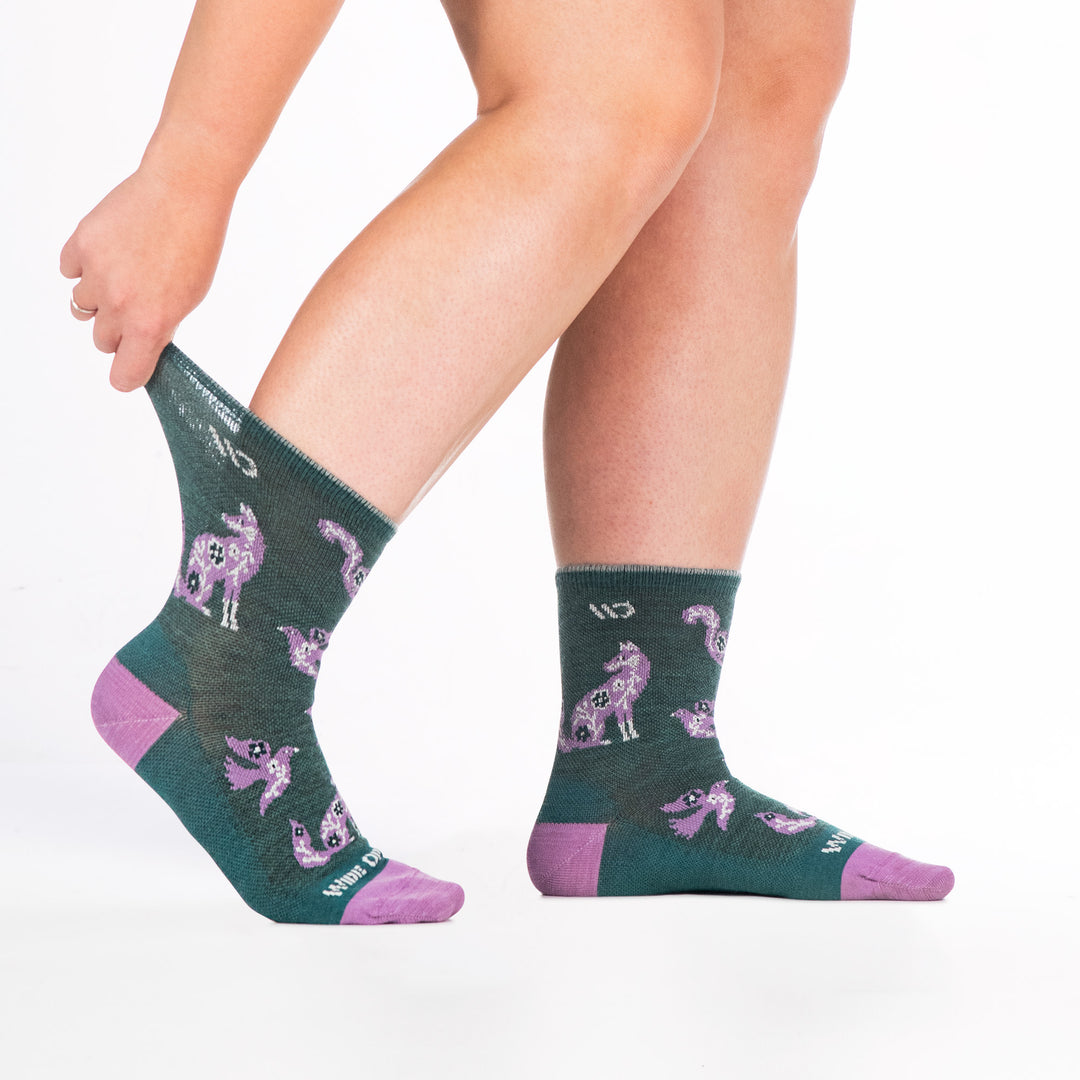 9516 teal micro crew sock with lavender heel/toe, white logo, shown fromn the side feet to the right cuff stretched