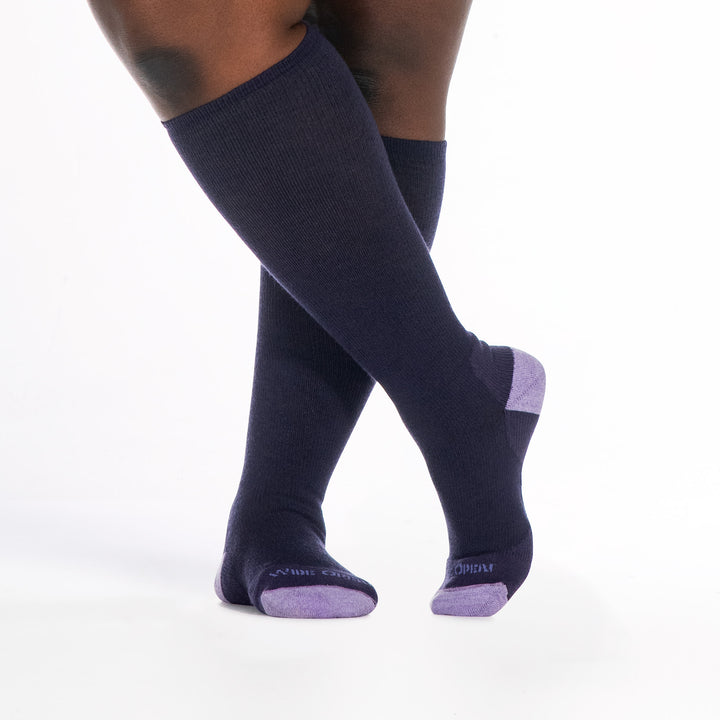 9517 blackberry knee high sock with lavender heel/toe/logo, shown from the front with legs crossed 