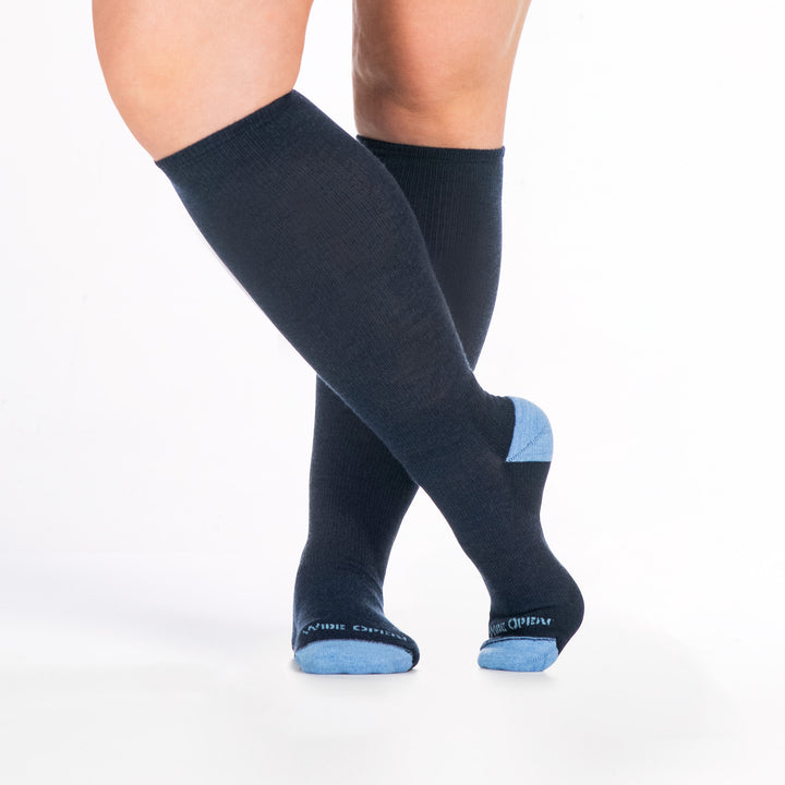 9517 denim knee high sock with light blue heel/toe/logo, shown from the front with feet crossed