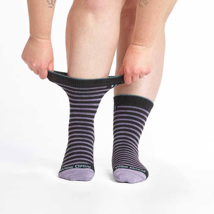 9518 charcoal crew sock with purple stripes, teal heel/toe, and light blue cuff trim, shown from front with cuff stretched.