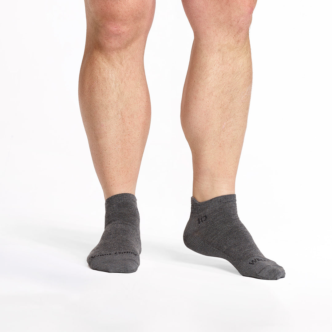 models feet facing forward wearing the 9013 lightweight ankle sock in gray 