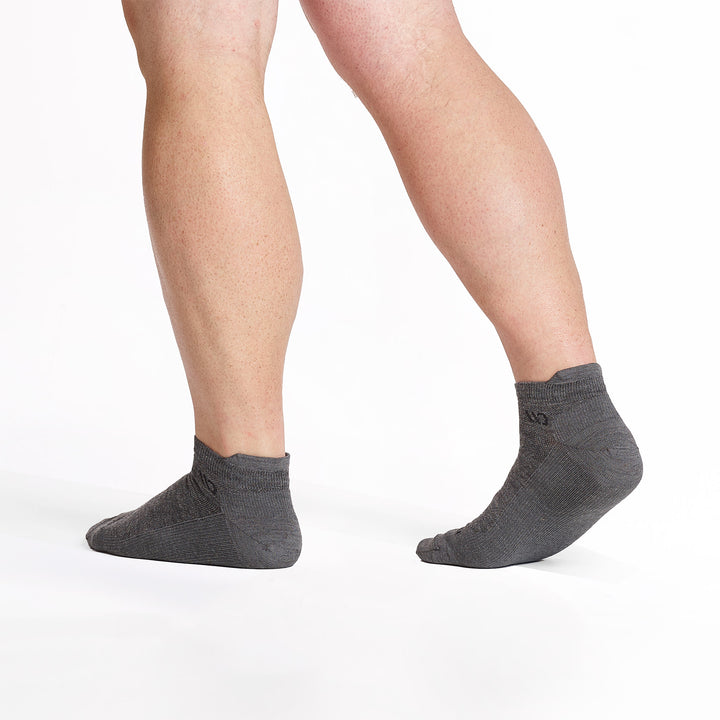 model walking away wearing the 9013 lightweight ankle sock in gray 
