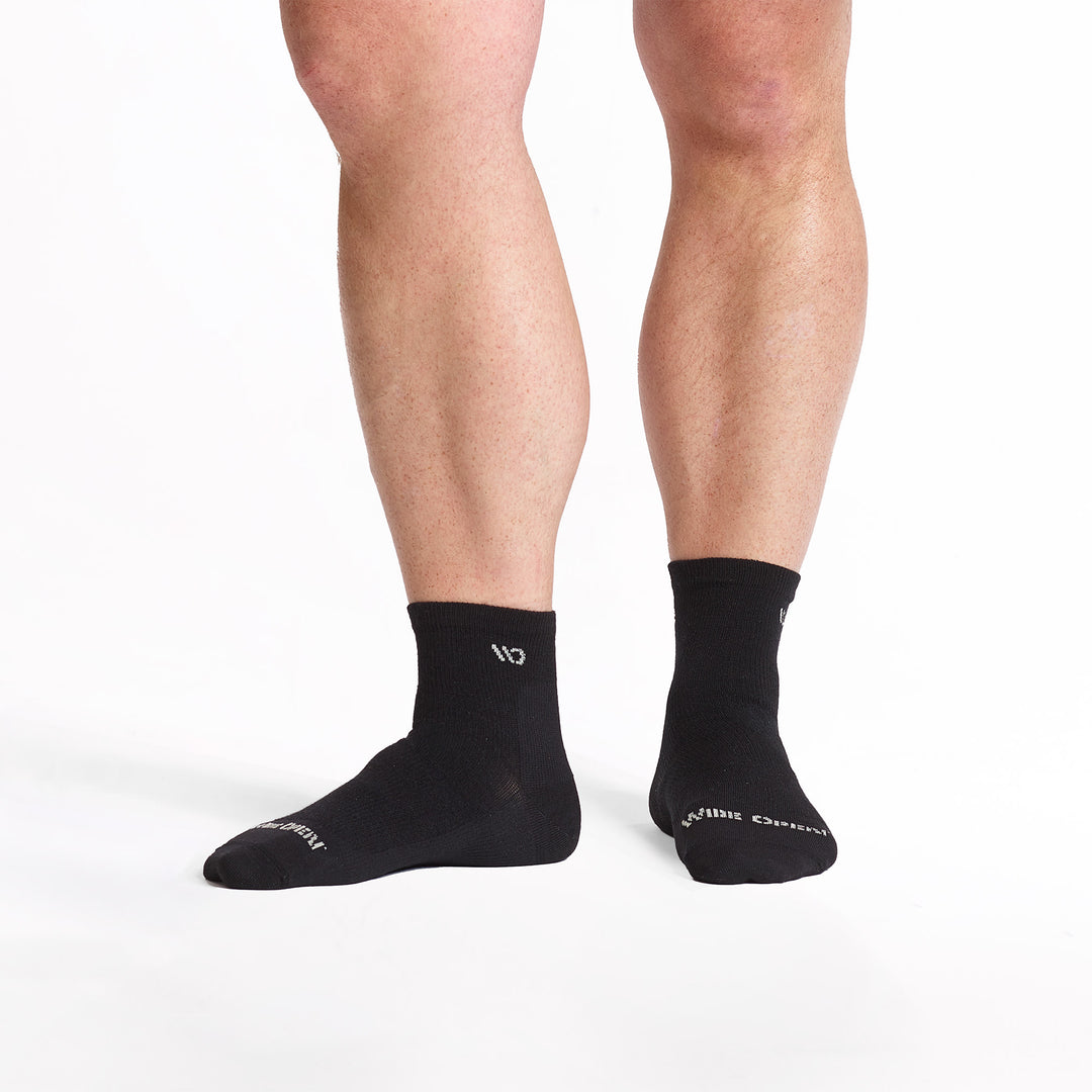 Model standing with left foot to the side wearing the 9014 lightweight quarter in black 