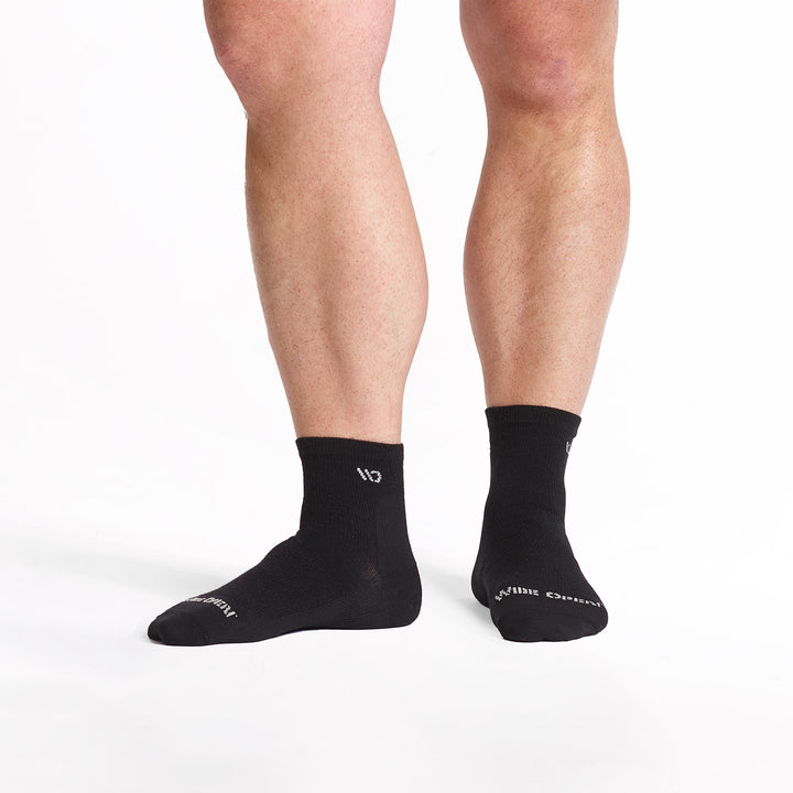 Model standing with left foot to the side wearing the 9014 lightweight quarter in black 