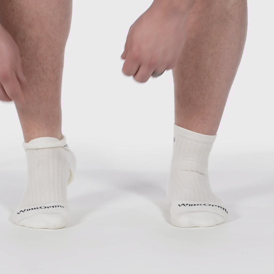 Video of model putting on the 9004 white quater socks